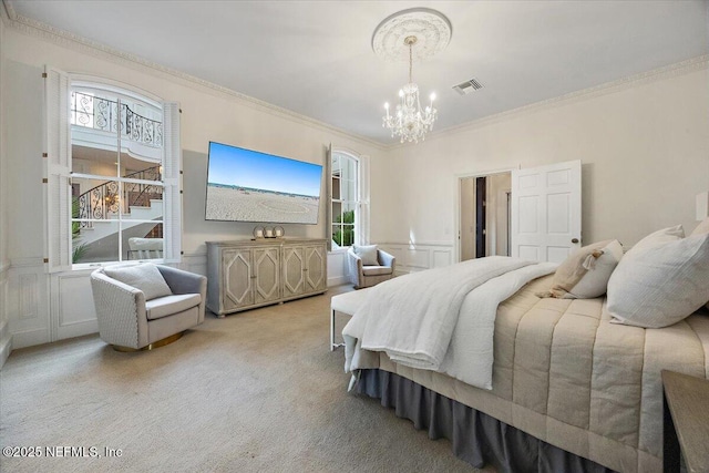 carpeted bedroom featuring a notable chandelier and crown molding