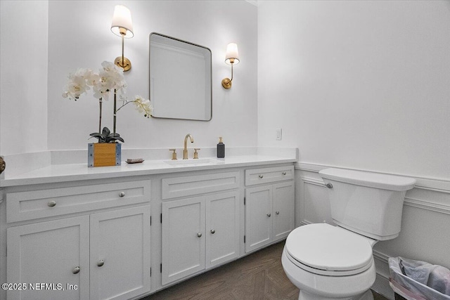 bathroom with toilet and vanity