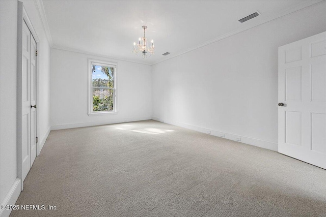 empty room featuring carpet, crown molding, and a notable chandelier