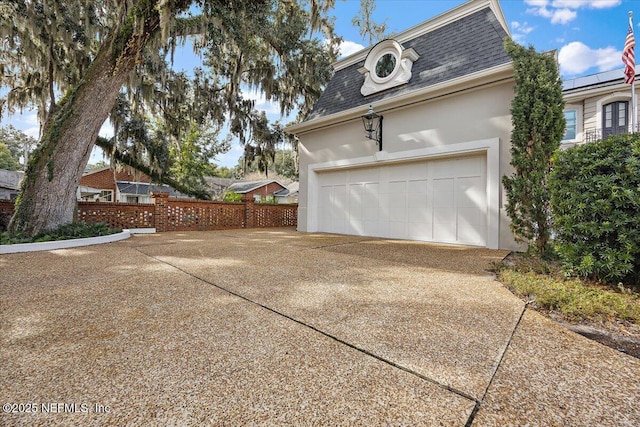 view of side of home featuring a garage