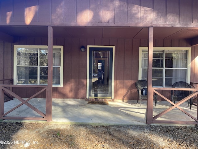 doorway to property featuring covered porch