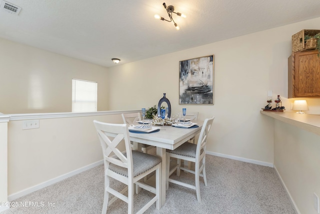 dining area with light carpet