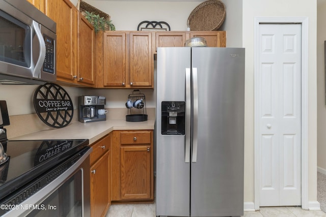 kitchen with stainless steel appliances and light tile patterned floors