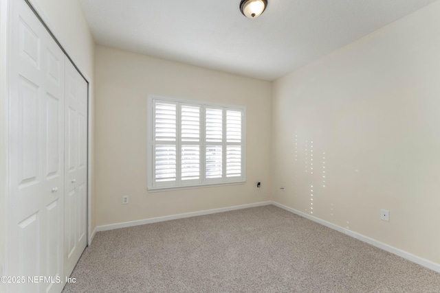 unfurnished bedroom featuring carpet floors and a closet