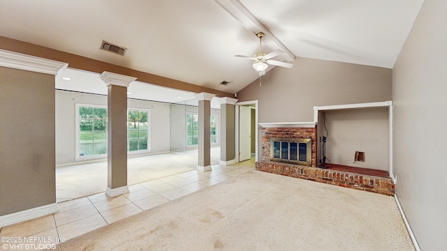 living room with ceiling fan, light colored carpet, a brick fireplace, vaulted ceiling with beams, and decorative columns