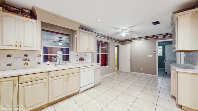 kitchen with white appliances, light tile patterned floors, sink, backsplash, and ceiling fan