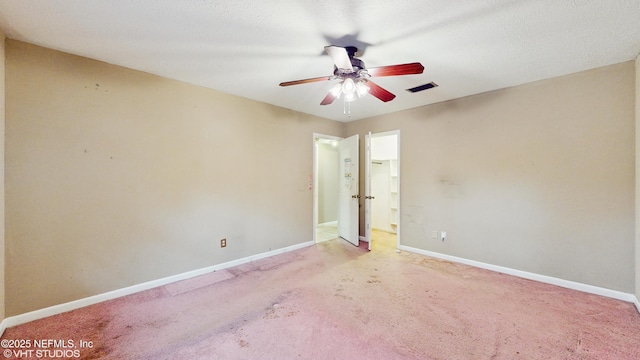 spare room with ceiling fan and light carpet