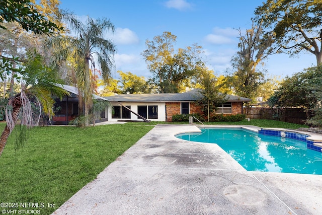 view of pool with a patio area and a lawn