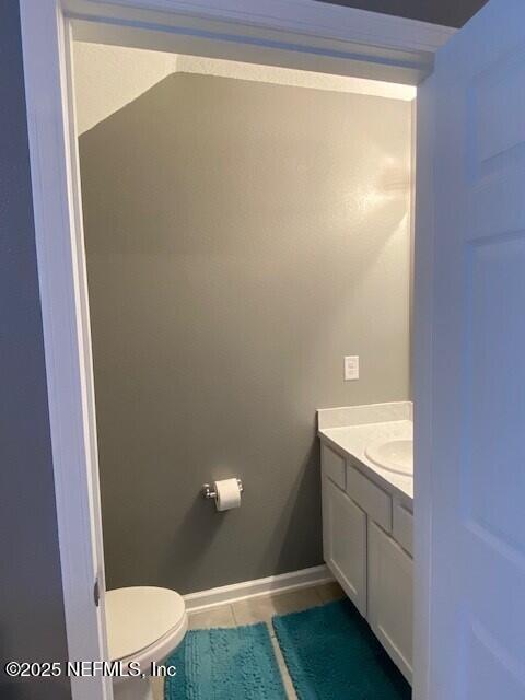 bathroom with tile patterned floors, toilet, and vanity