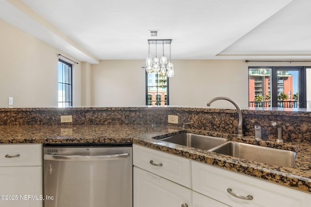 kitchen with dishwasher, sink, dark stone countertops, and white cabinets