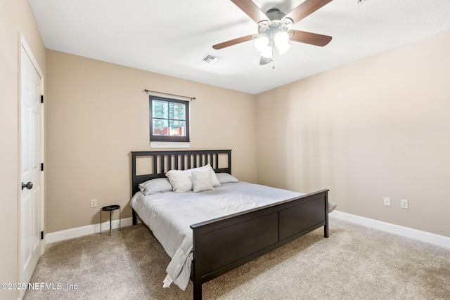 bedroom featuring ceiling fan and light carpet