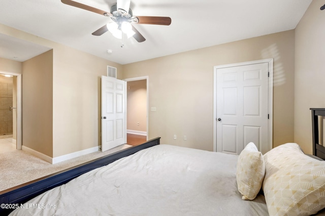 carpeted bedroom featuring ceiling fan and ensuite bathroom