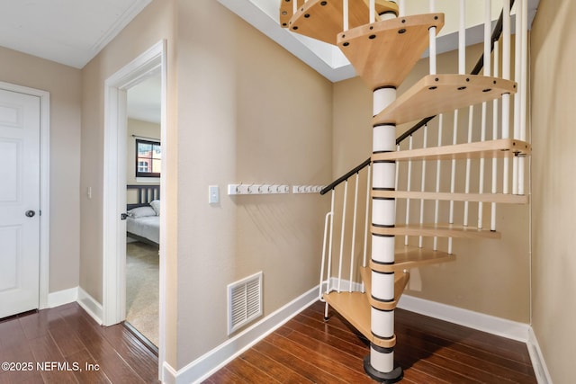 staircase featuring hardwood / wood-style flooring and a skylight