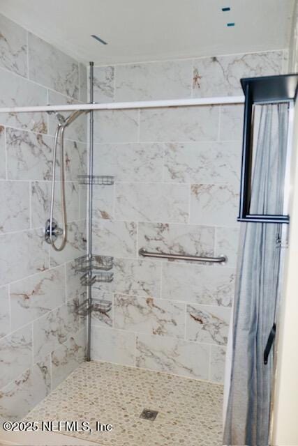 bathroom with a tile shower