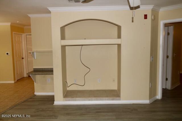 interior space featuring crown molding and dark hardwood / wood-style floors