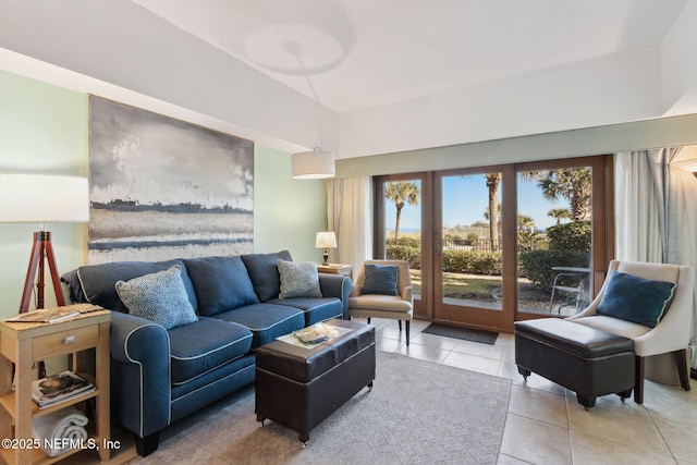 living area featuring lofted ceiling and light tile patterned floors