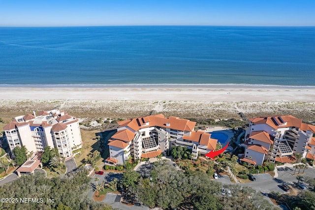 drone / aerial view with a beach view and a water view