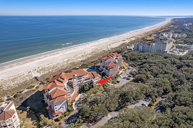 birds eye view of property with a beach view and a water view