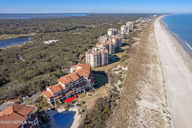 drone / aerial view with a water view and a beach view