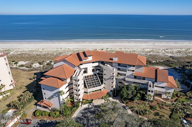 aerial view with a water view and a view of the beach