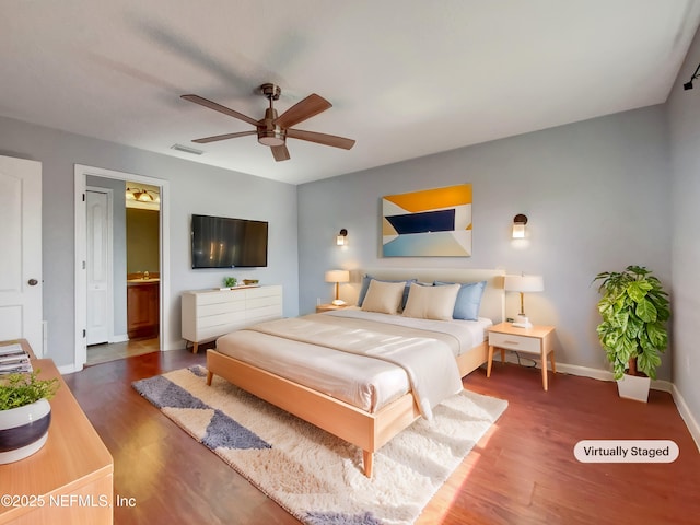 bedroom featuring ceiling fan, dark hardwood / wood-style floors, and ensuite bath