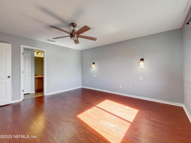 empty room with dark hardwood / wood-style floors and ceiling fan