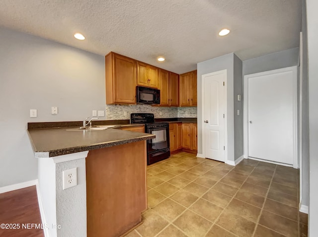 kitchen with kitchen peninsula, sink, a textured ceiling, black appliances, and decorative backsplash