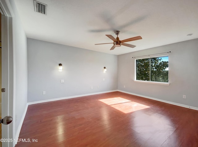 empty room with wood-type flooring and ceiling fan