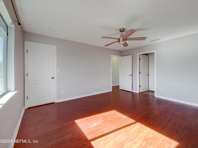 interior space with ceiling fan and dark wood-type flooring