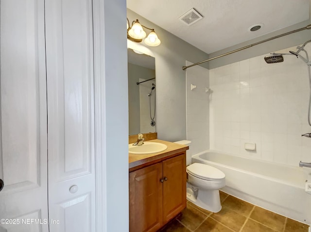 full bathroom featuring vanity, toilet, tiled shower / bath, and tile patterned flooring