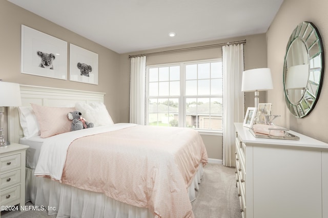 bedroom featuring light colored carpet