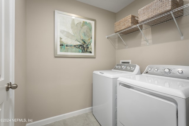 laundry room with light tile patterned floors and washing machine and dryer