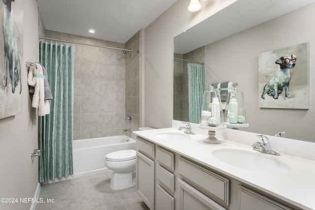 full bathroom featuring toilet, vanity, tile patterned flooring, and shower / bath combination with curtain