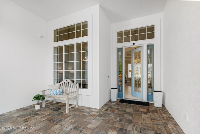 view of exterior entry featuring stucco siding