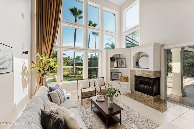 sunroom featuring a fireplace and visible vents