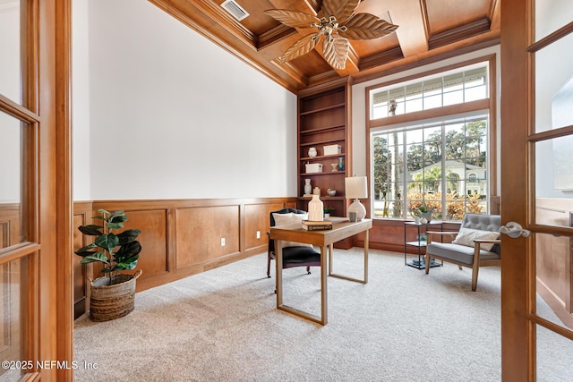 office with built in features, crown molding, visible vents, light carpet, and coffered ceiling