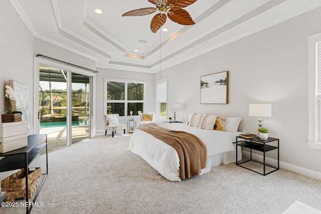 bedroom with crown molding, carpet, a raised ceiling, and access to exterior