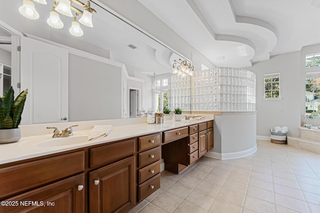 full bathroom with double vanity, baseboards, visible vents, tile patterned flooring, and a sink