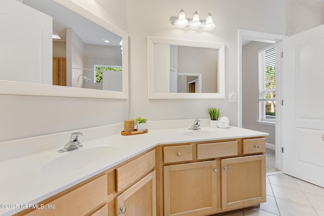 bathroom with tile patterned flooring, a sink, and double vanity