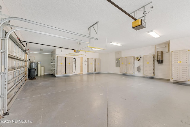 garage featuring electric panel and a garage door opener