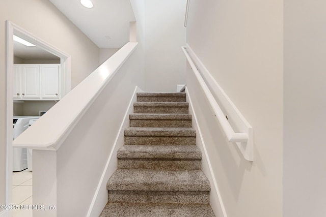 stairway with washer / clothes dryer, tile patterned flooring, and recessed lighting