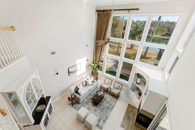 living room featuring light tile patterned floors, plenty of natural light, and baseboards