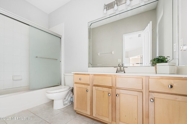 bathroom featuring toilet, shower / bath combination with glass door, vanity, and tile patterned floors