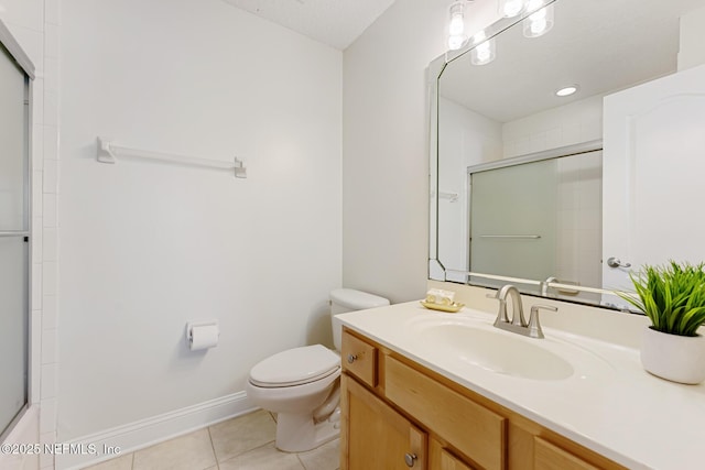 full bath with baseboards, vanity, toilet, and tile patterned floors