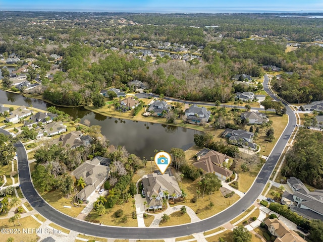 drone / aerial view featuring a residential view and a water view