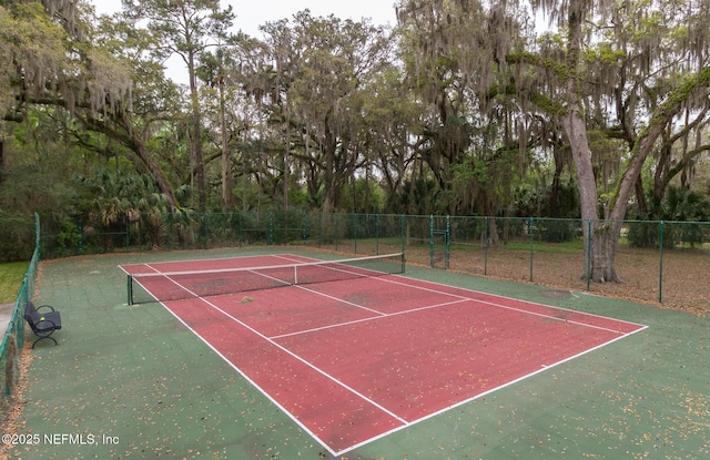 view of tennis court featuring fence