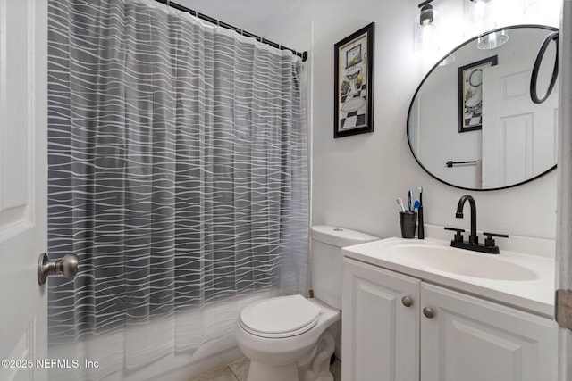 bathroom featuring toilet, vanity, and tile patterned flooring