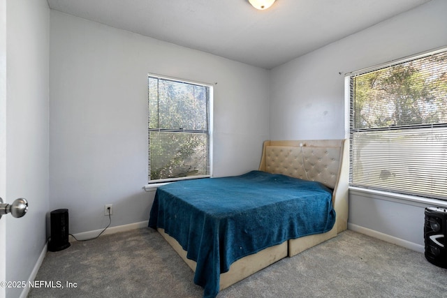 carpeted bedroom featuring multiple windows