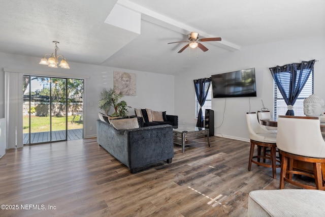 living room featuring ceiling fan with notable chandelier, a textured ceiling, dark hardwood / wood-style floors, and lofted ceiling with beams