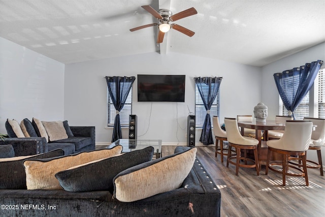 living room featuring ceiling fan, lofted ceiling with beams, a textured ceiling, and hardwood / wood-style flooring